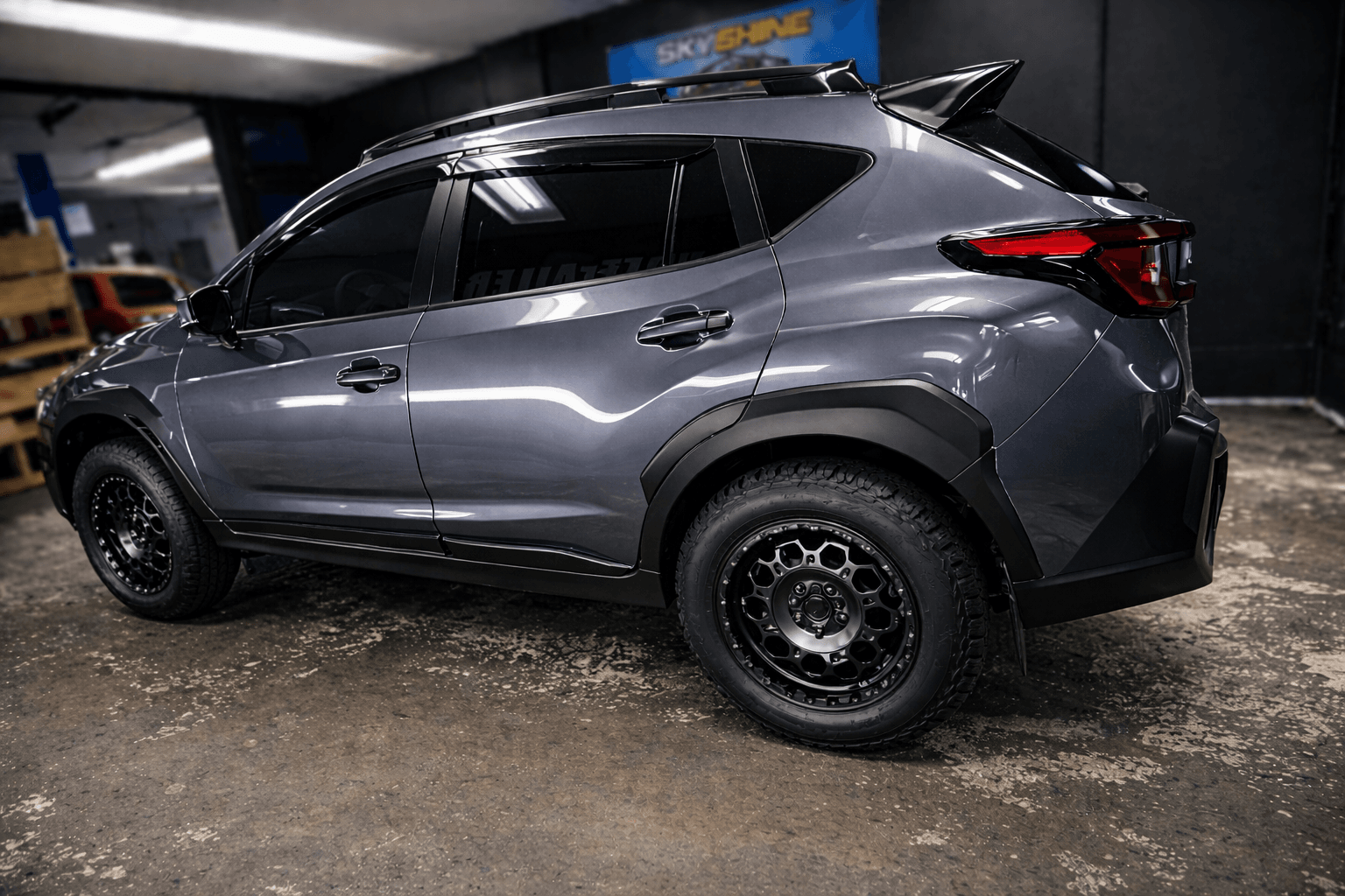 Sleek SUV parked in garage after exterior detailing